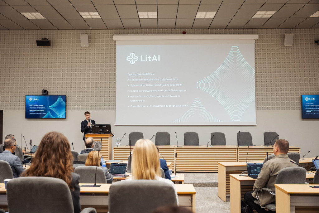 Henrikas Krukauskas presents to an audience about LitAI and the data infrastructure supporting AI solutions. His presentation outlines responsibilities including data confidentiality and acquisition. LitAI data space development. AI research projects. and consultations on the legal framework for data and AI.